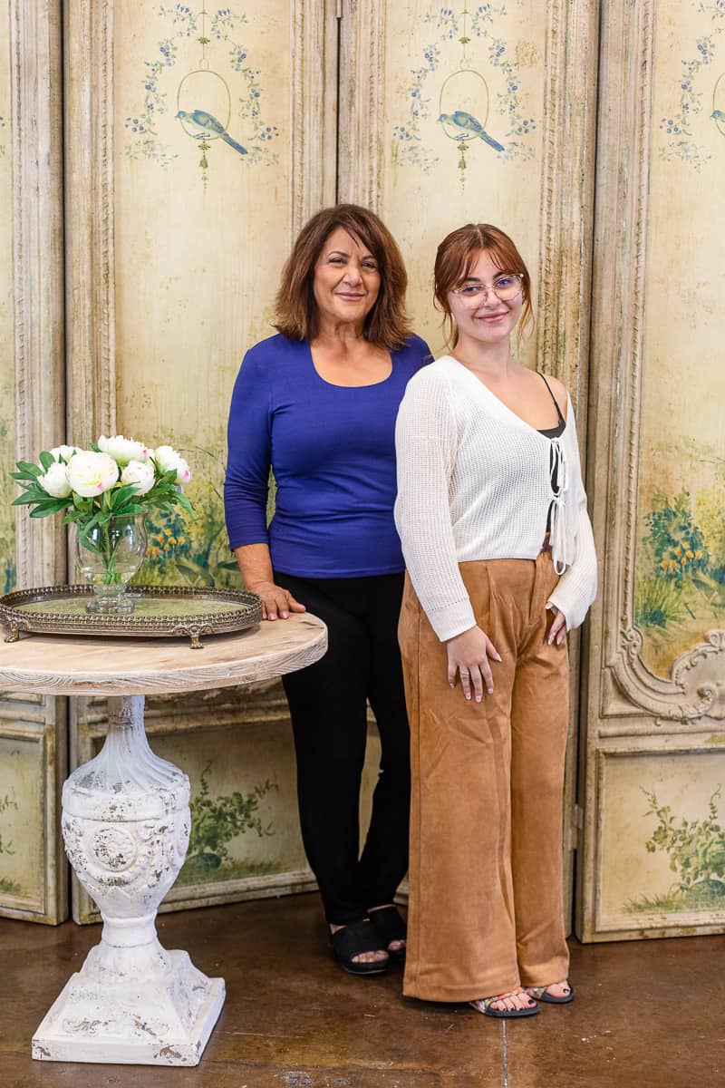 Mother and daughter pose together in their shop